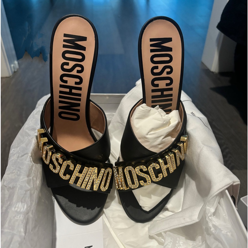 Moschino crystal embellished logo heel mules.